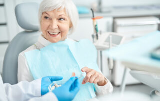 Senior lady asking her dentist questions about dental implants