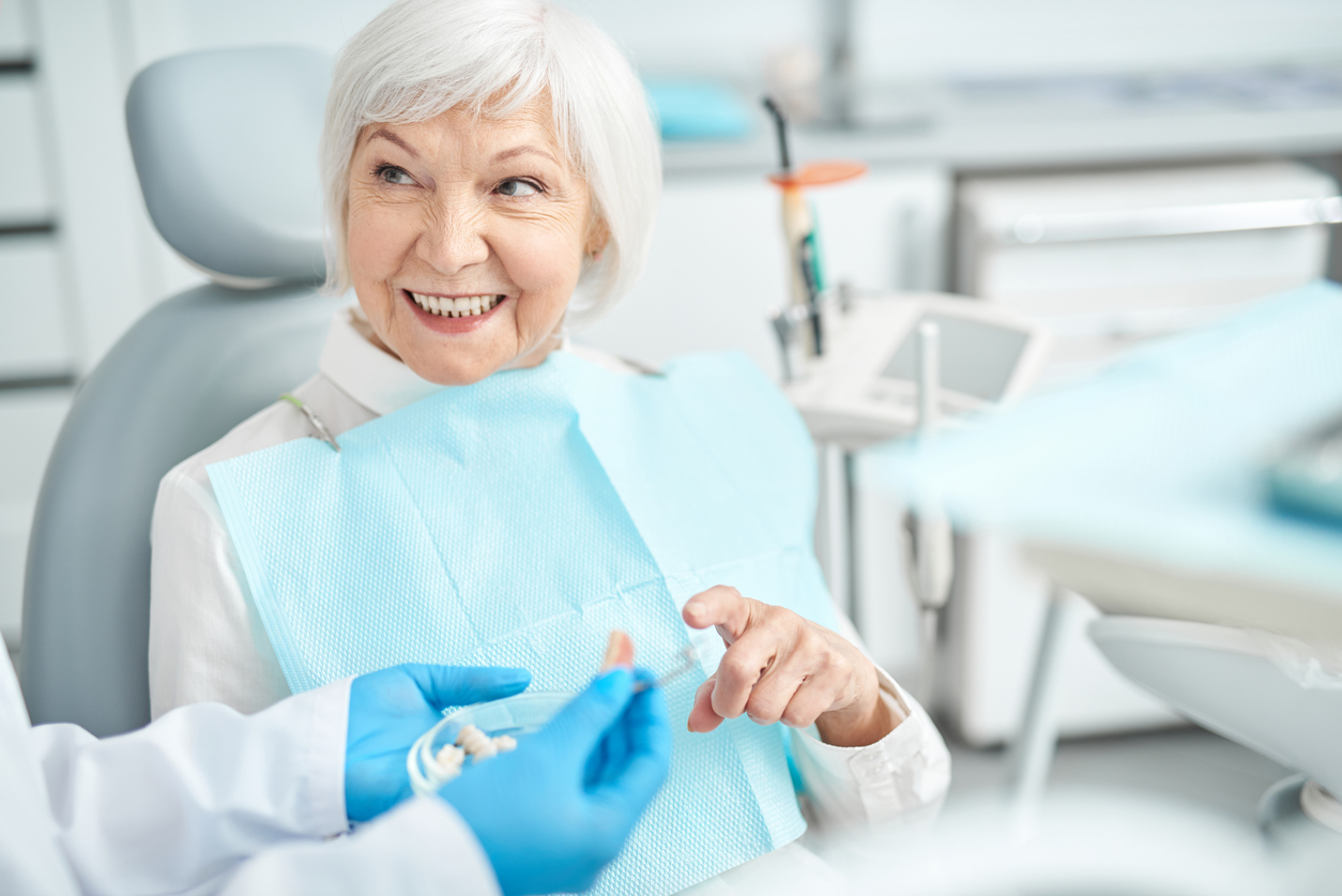 Senior lady asking her dentist questions about dental implants